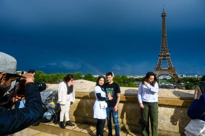 Turisti se fotografišu pored Ajfelovog tornja. Pariz, Francuska: Turisti se fotografišu pored Ajfelovog tornja. Popularna turistička destinacija. Eiffel Tower.