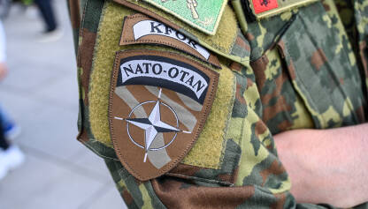 NATO i KFOR oznaka na ramenu vojnika na Kosovu. NATO simbol. NATO i KFOR oznaka na ramenu vojnika. Međunarodne mirovne snage na Kosovu koje predvodi NATO. Vojnici KFOR-a u Prištini, Kosovo. Amblem.