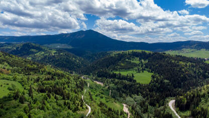 Planine u proljeće, snimak dronom. Zelena brda i šume u maju. Planina Vlašić, Bosna i Hercegovina. Planinarenje.