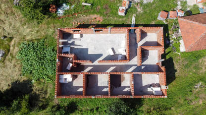 Gradnja kuće Kuća u izgradnji snimak dronom. Izgradnja kuće na selu. Zidovi od cigle na stambenoj kući. Gradilište.