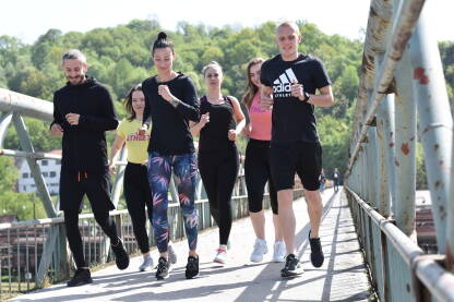 Trening Trening na otvorenom. Grupa mladih ljudi trči. Fitnesom do zdravlja.