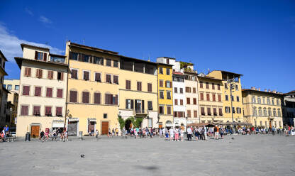 Firenca, Italija: Ljudi hodaju trgom Piazza Santa Croce. Firenca, Italija: Ljudi hodaju trgom Piazza Santa Croce. Turisti istražuju grad. Historijske građevine u centru grada.