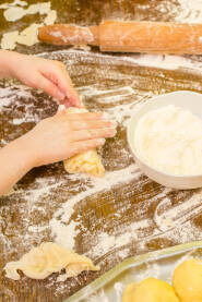 Childrens hands preparing dough for cookies Dječije ruke pripremaju tijesto za kolače