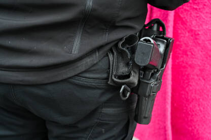 Pištolj na opasaču policajca. Pištolj na opasaču policajca. Pištolj u futroli pripadnika specijalne policije. Oružje.