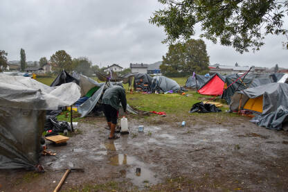 Improvizovani migrantski kamp Čovjek stoji u blatu, između improvizovanih šatora za izmjeglice i migrante u Velikoj Kladuši, Bosna i Hercegovina.