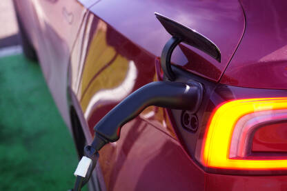 Punjač električnog automobila uključen na stanici za punjenje.