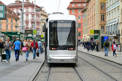 Graz, Austrija: Tramvaj sa putnicima. Ljudi u šetnji. Graz, Austrija: Zgrade na glavnoj ulici. Ljudi hodaju na ulici. Tramvaj sa putnicima. Herrengasse bulevar.