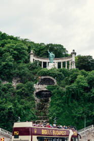 Gellert brdo Gellert brdo. Spomenik Gelerta. U podnožju brda prolazi autobus sa turistima. Budimpešta. Mađarska.