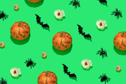 Pozadina za noć vještica Pozadina za noć vještica - Halloween. Cvijeće, šišmiši, oći i tikve na zelenoj pozadini.