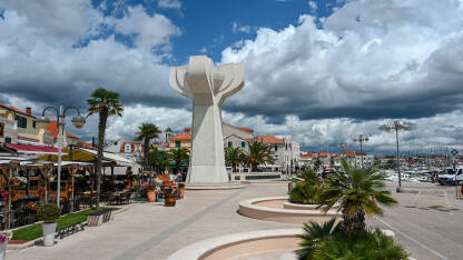 Vodice, Hrvatska. Spomenik NOB u centru grada. Vodice, Hrvatska. Turisti šetaju centrom grada. Spomenik NOB u centru grada. Mala luka na Jadranskom moru.
