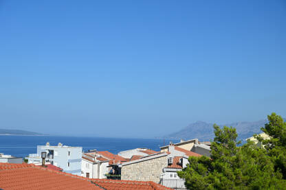 Apartmani na moru Apartmani na moru. Krovovi kuća uz Jadransko more. Aparmanizacija obale. Makarska, Hrvatska.